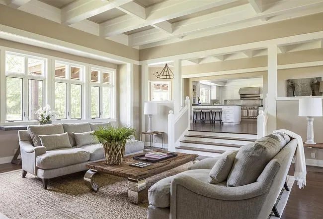 A furnished living room with gray and cream tones